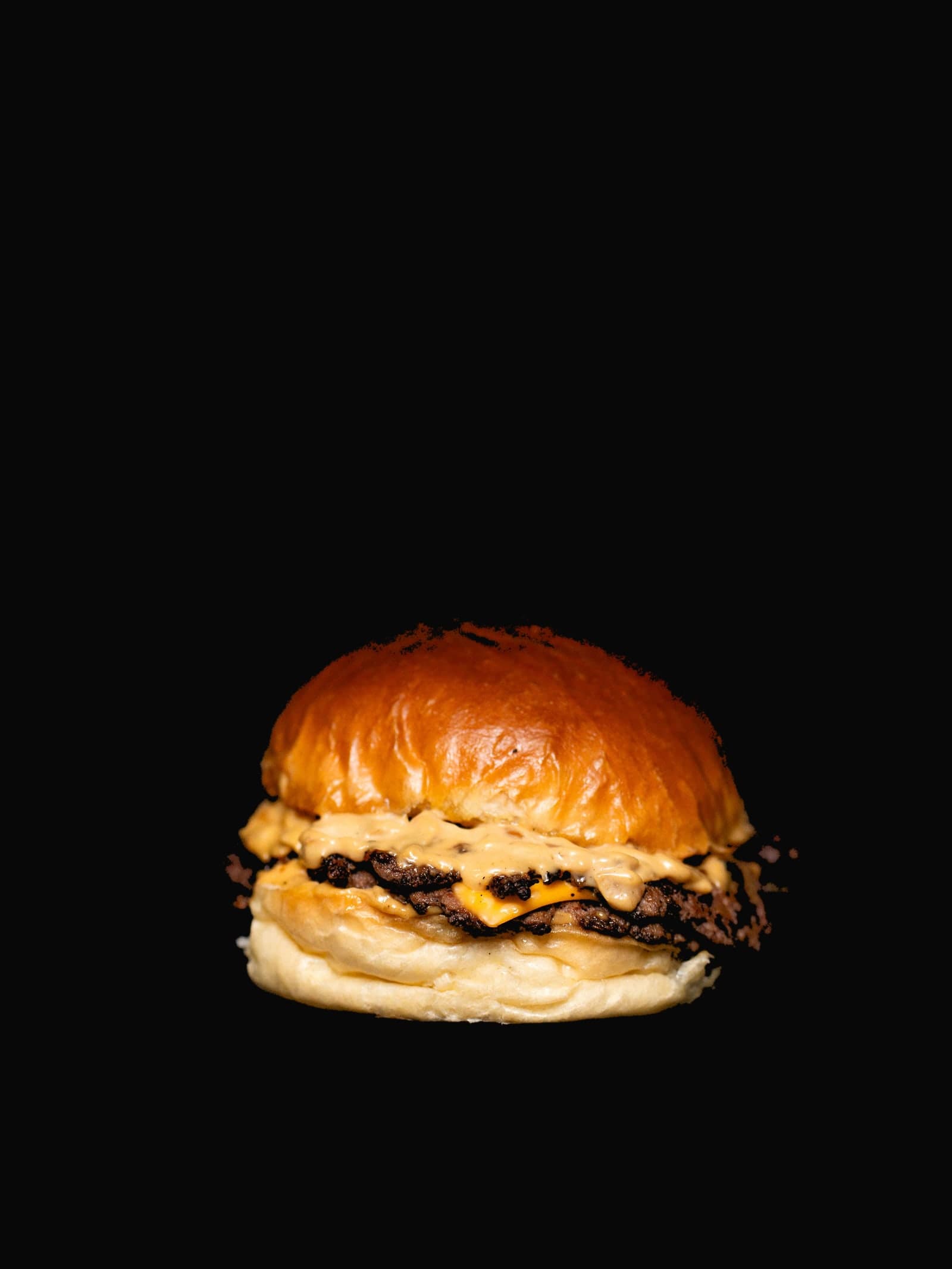 The Bro Burger — Double smashed beef, melted cheese, house Bro sauce and pickles on a buttered brioche bun. The one that started it all.