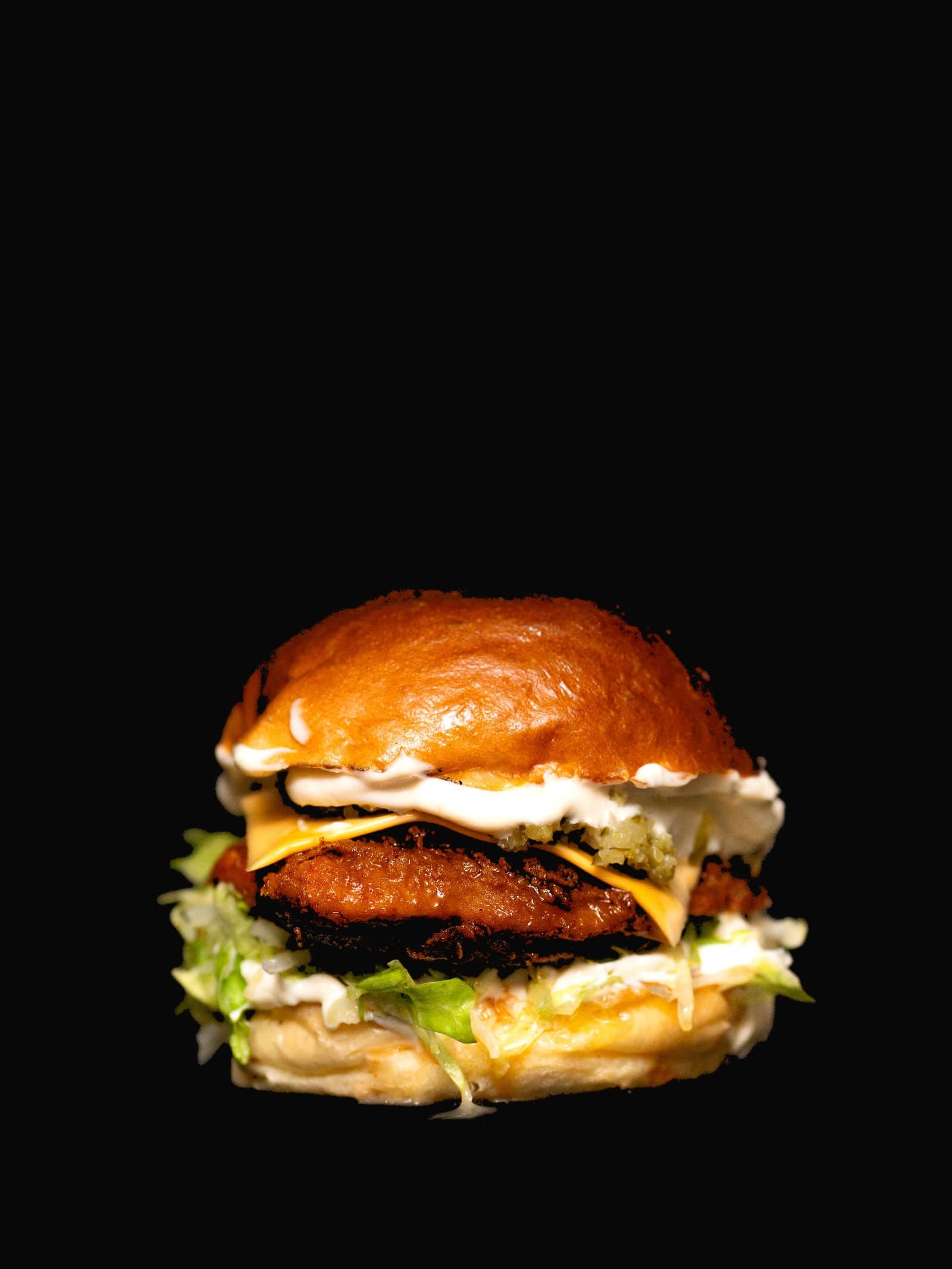 Hot Honey Chicken — Buttermilk-fried chicken thigh glazed in hot honey, with slaw and pickles on toasted brioche.